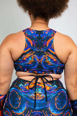 Back view of ShadowFlame Teaser Top featuring vibrant dragon design and crisscross straps, perfect for rave outfits.