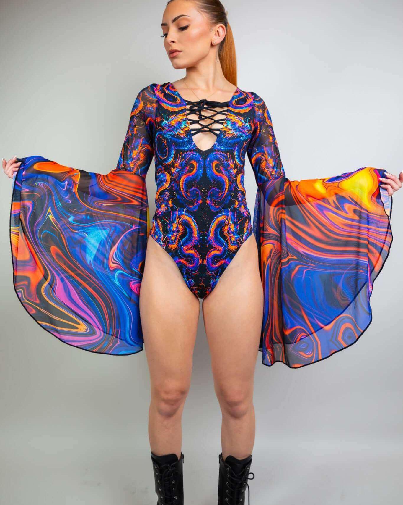 Model wearing the vibrant ShadowFlame Goddess Bodysuit, showcasing lace-up detail and flowing circle sleeves for rave outfits.