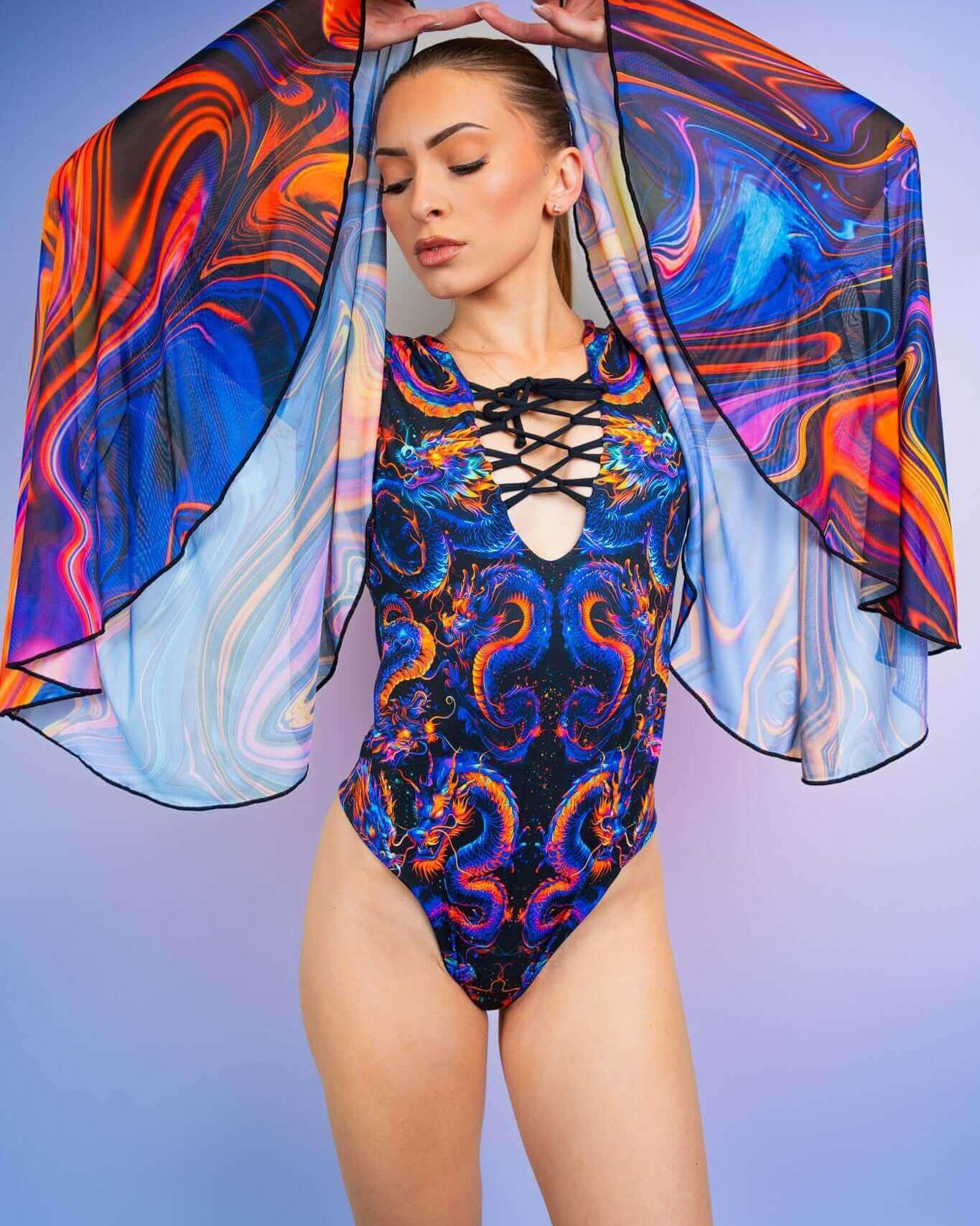 Model showcasing the ShadowFlame Goddess Bodysuit with lace-up detailing and colorful flowing sleeves, perfect for rave outfits.