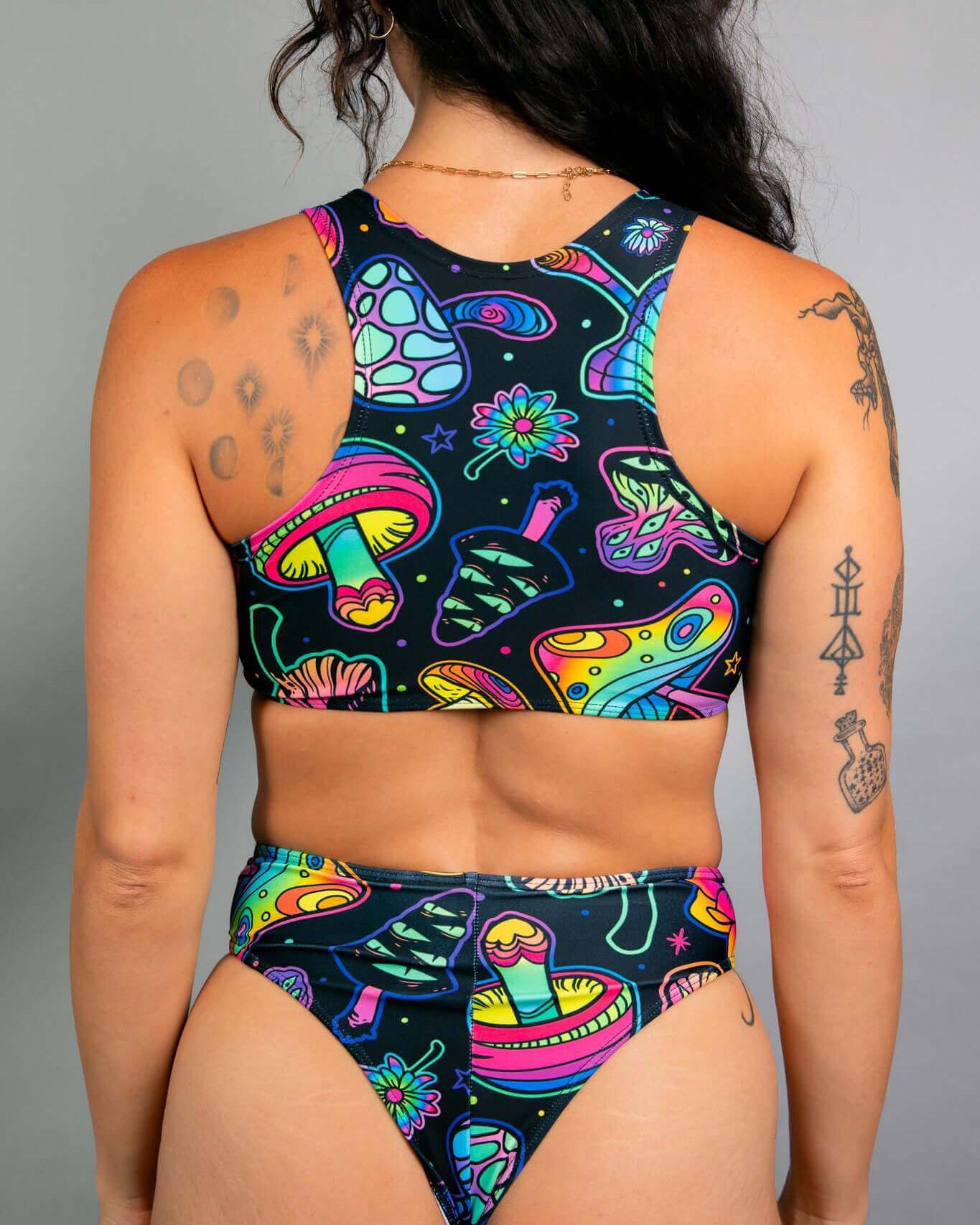 Back view of a woman in a colorful Shroomie! Keyhole Top and matching bottoms, ideal for rave outfits.