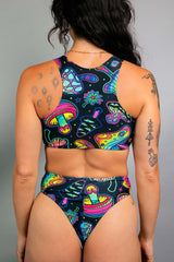 Back view of a woman in a colorful Shroomie! Keyhole Top and matching bottoms, ideal for rave outfits.