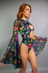 "Model in Freedom Rave Wear outfit with colorful mushroom print, bell sleeves, and a high-cut cutout bodysuit, perfect for raves."