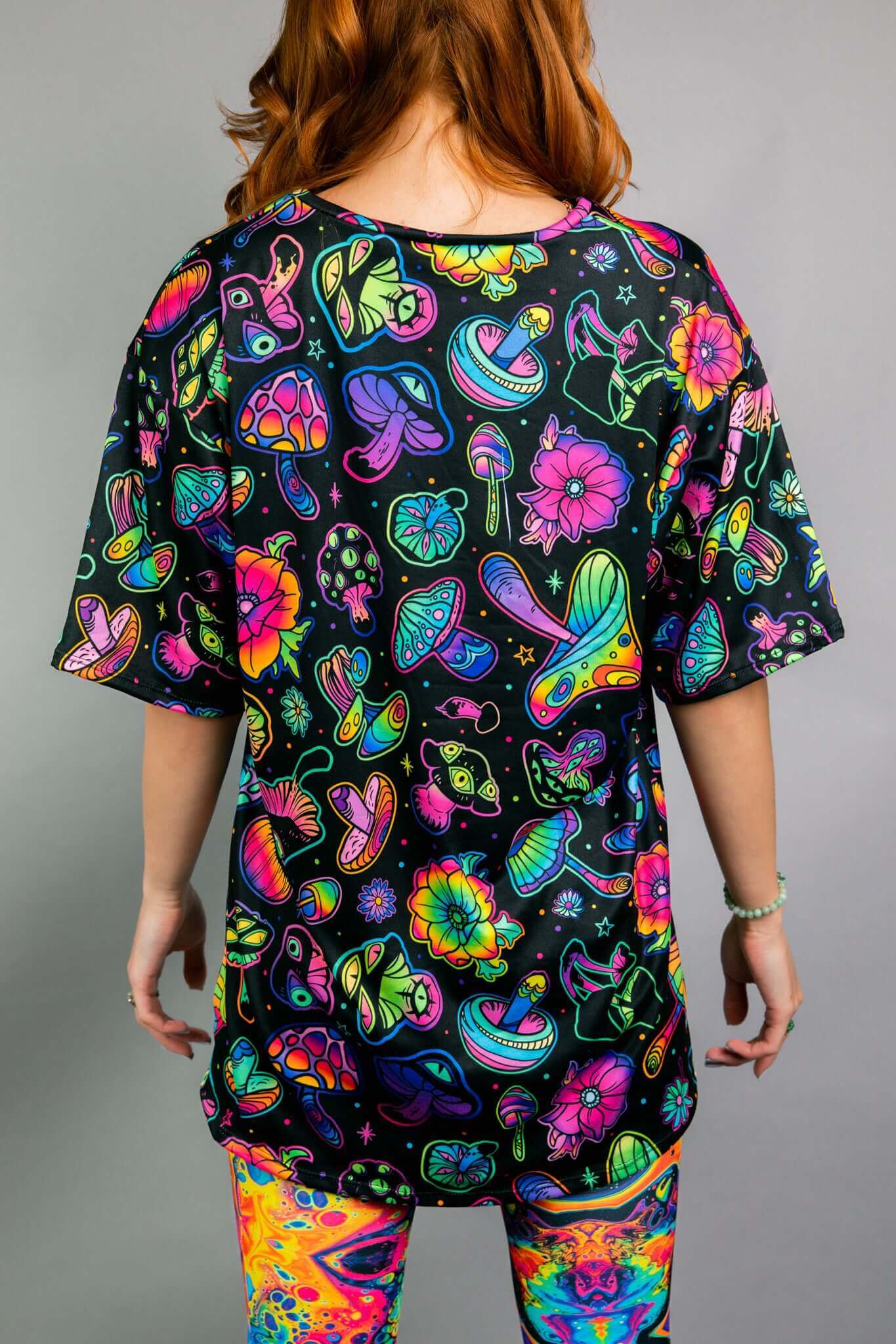 Freedom Rave Wear oversized tee with a vibrant, all-over psychedelic print featuring mushrooms, flowers, and abstract designs. Perfect for rave vibes.