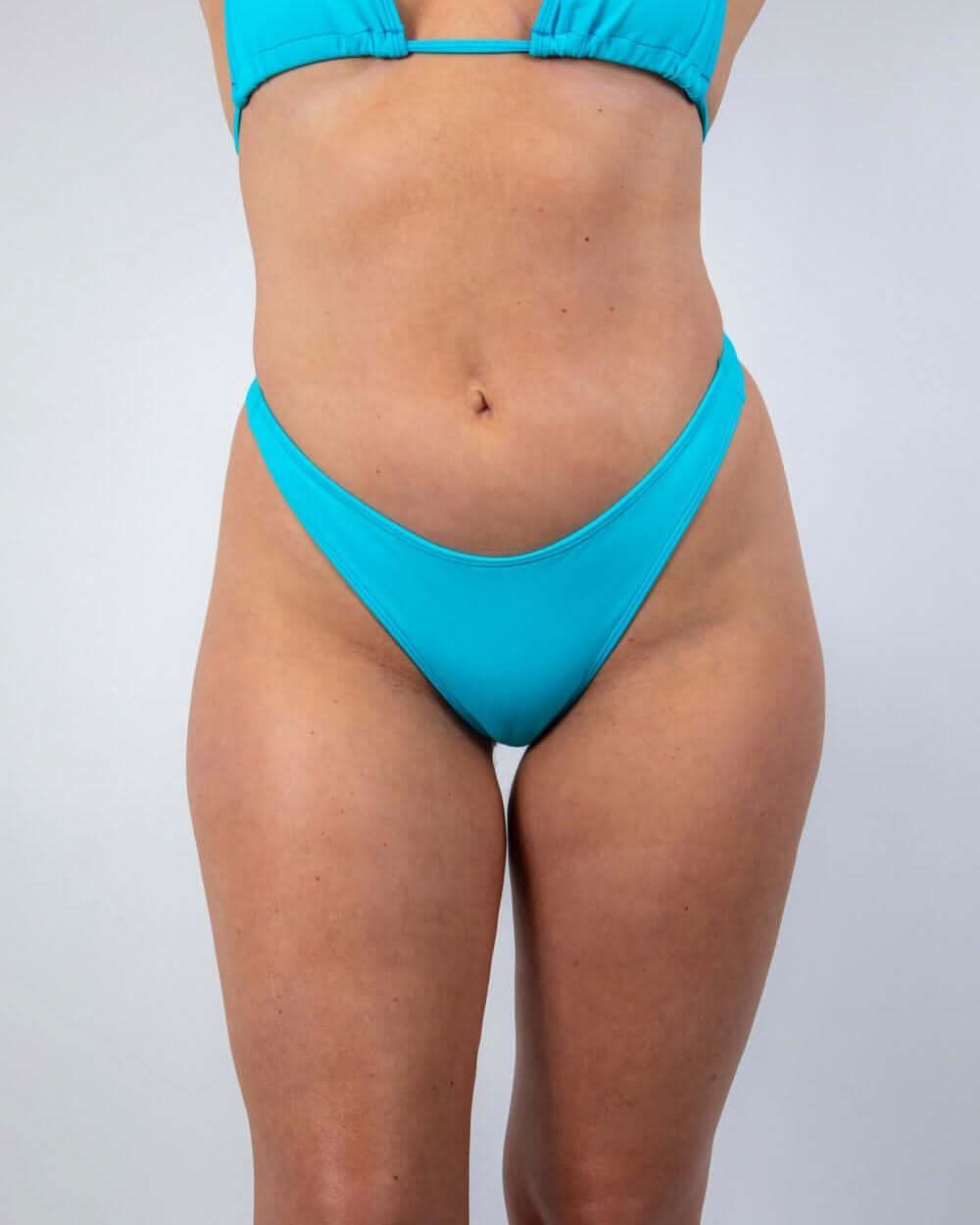 Siren Risk Bikini Bottoms in vibrant siren blue, high-cut silhouette for rave outfits and summer fun.
