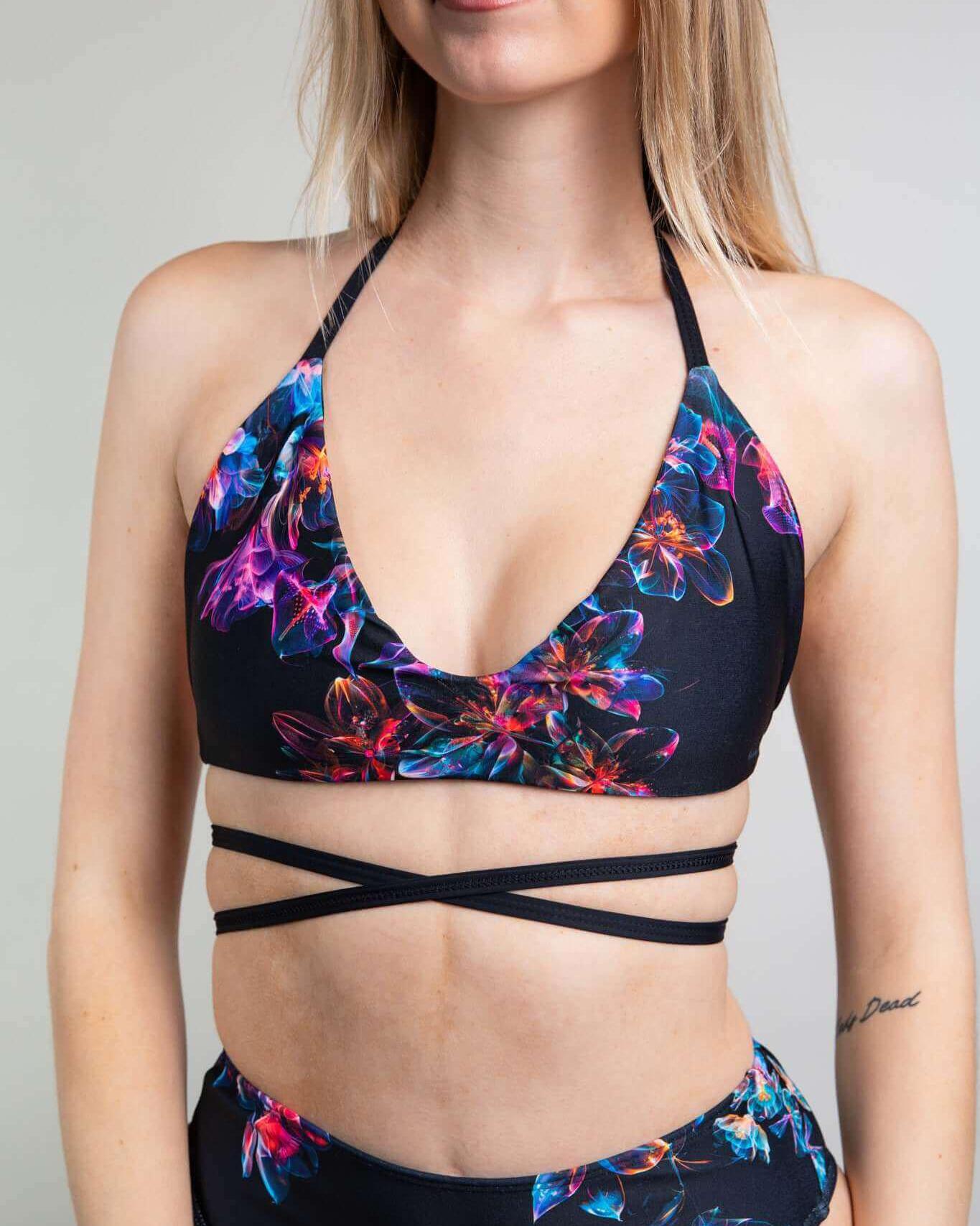 Model wearing Starflora Extra Mile Bralette, a floral rave outfit with criss-cross straps and a bikini-crop top design.