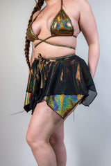 Flowy black mesh skirt with a shimmering gold and multi-color bikini set, perfect for rave outfits and festival wear.