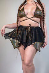 Model wearing a sparkly gold and black two-layered Starfire Fairy Skirt, perfect for rave outfits and special occasions.