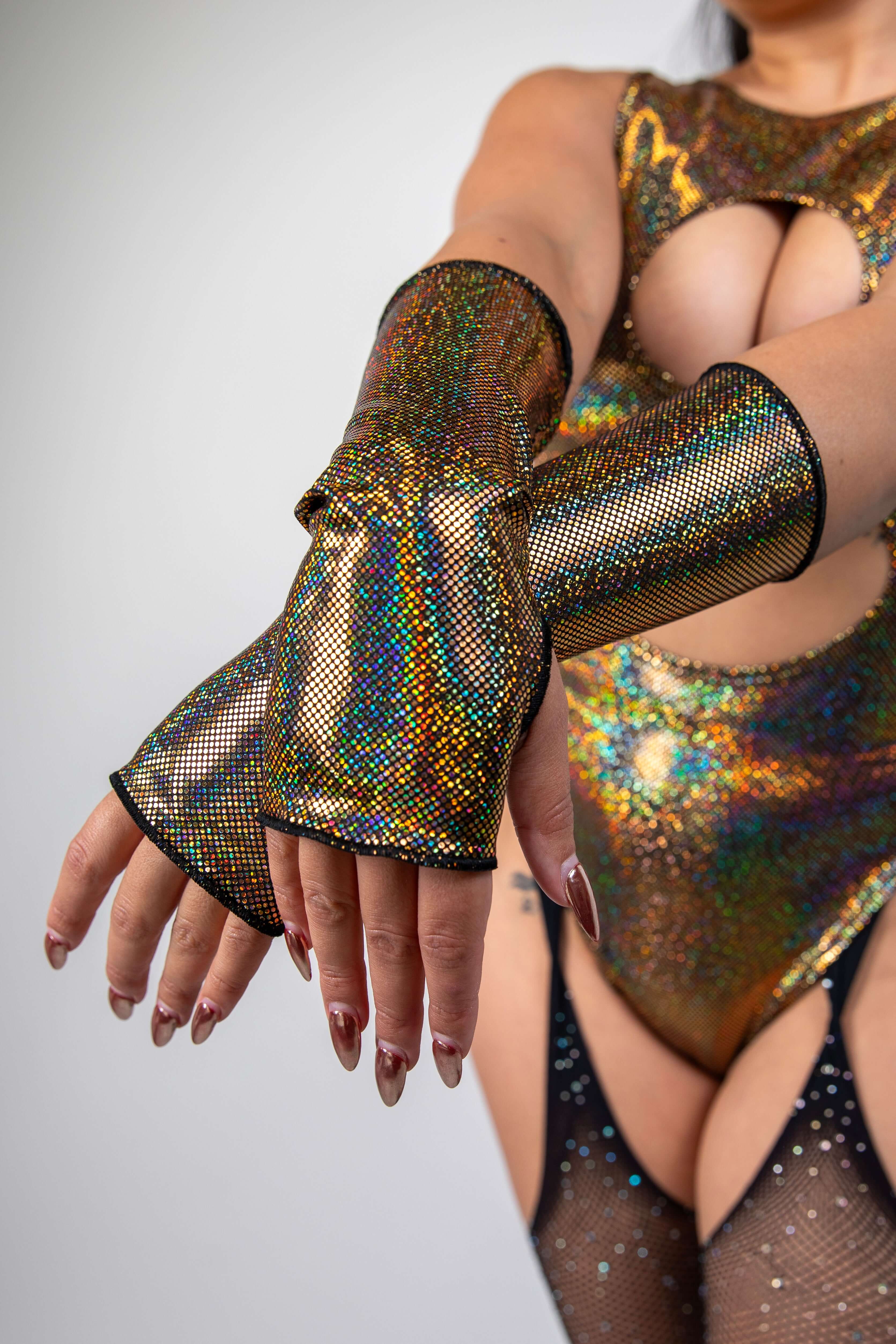 Sparkly gold Starfire Gloves with thumb holes, perfect for rave outfits and stylish events.