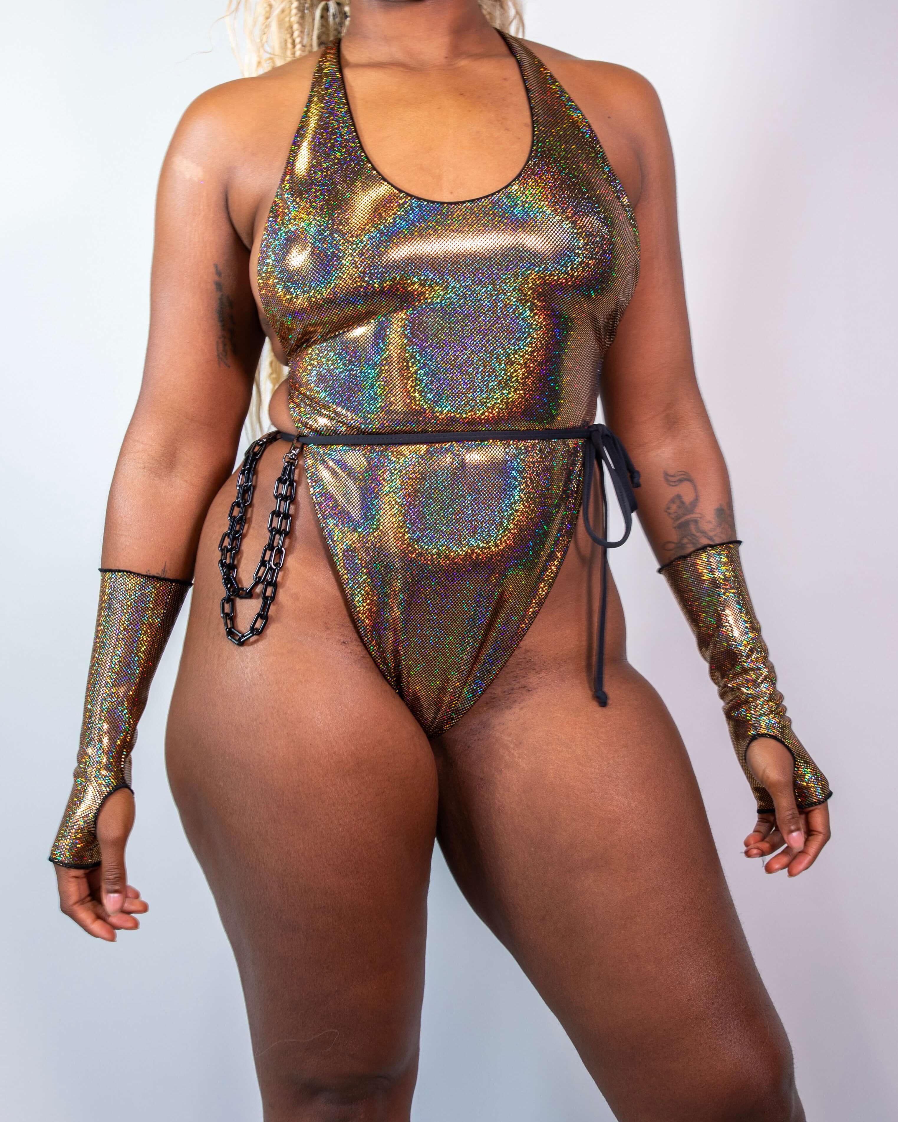 Model showcasing Starfire Temptation Cheeky One Piece, featuring gold shimmer and adjustable ties for rave outfits.