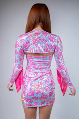 Back view of a sparkly pink cow print shrug with fringe, perfect for rave outfits and adding fun to any look.