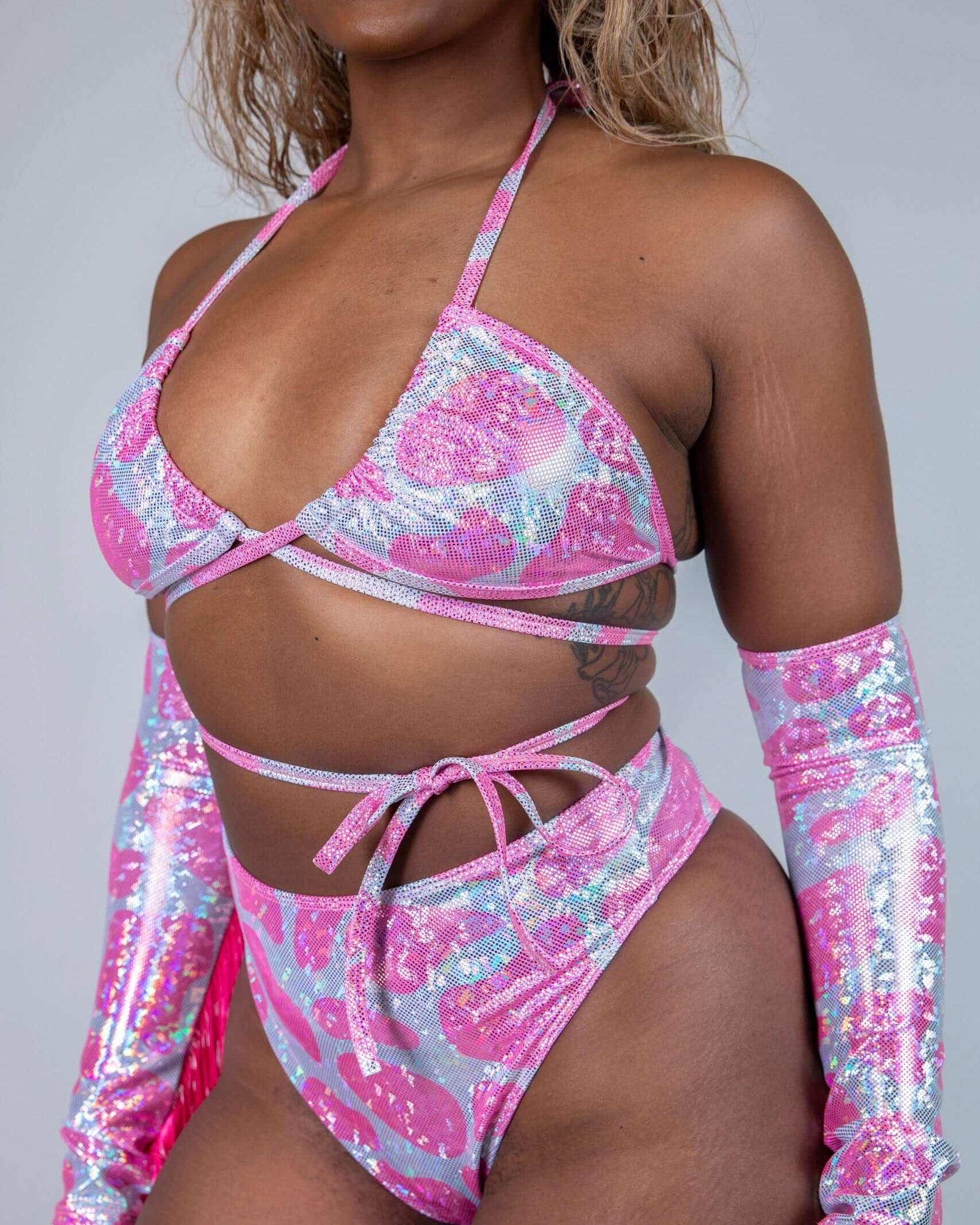 Model in a sparkly pink wrap bikini top and matching high-waisted bottoms, perfect for rave outfits and summer fun.