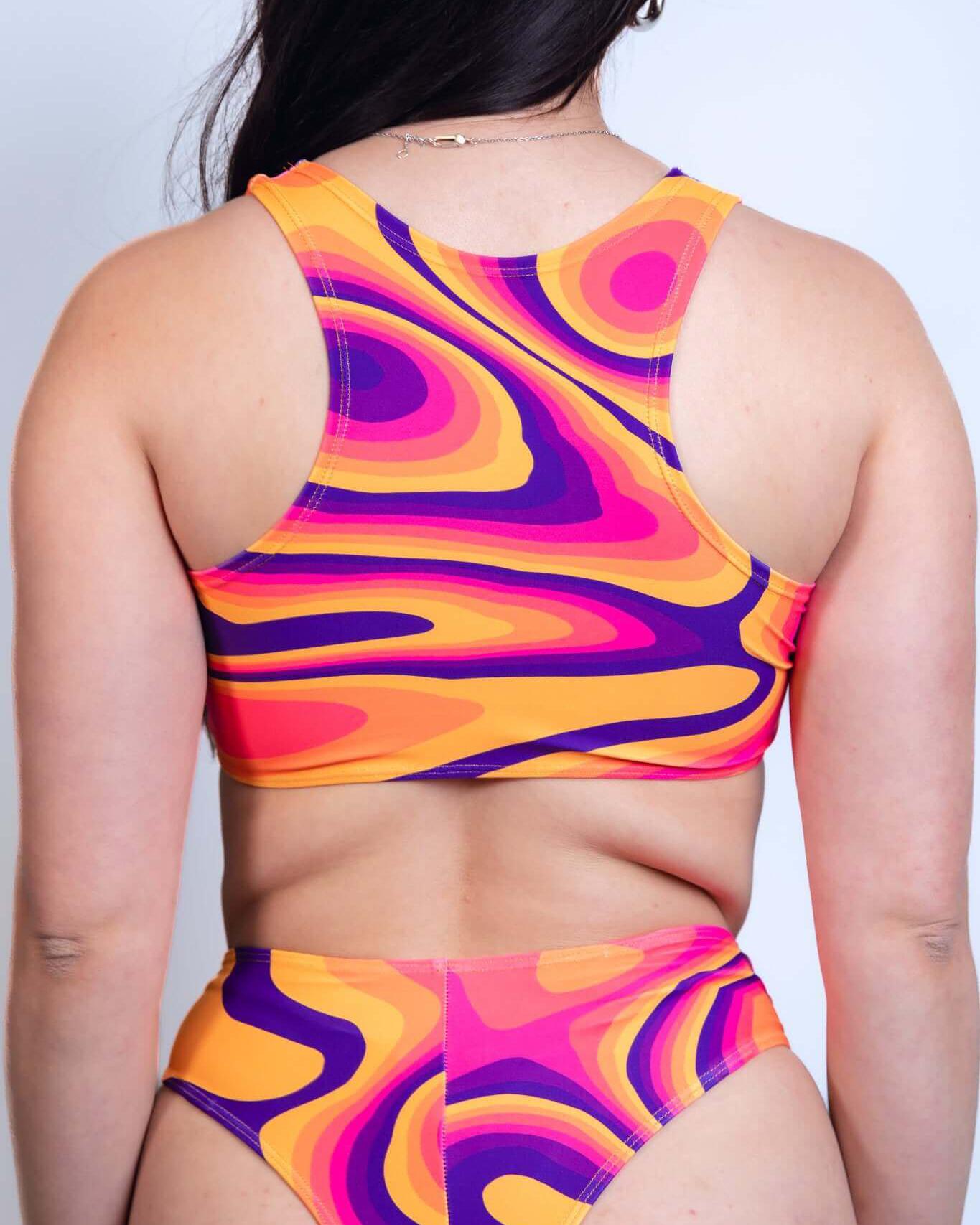 Back view of a vibrant Tangerine Tango Keyhole Top with colorful swirls, perfect for rave outfits.