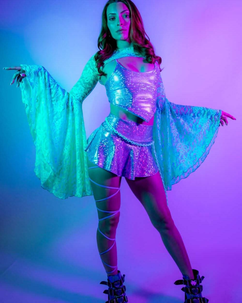 Model wearing Calypso Lace Bell Sleeves in a vibrant rave outfit with shimmering details.