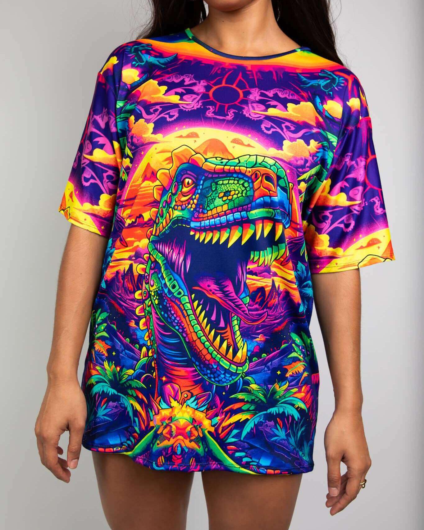 Model wearing Titan Oversized Softee t-shirt with colorful T-Rex graphic, ideal for rave outfits and dinosaur lovers.