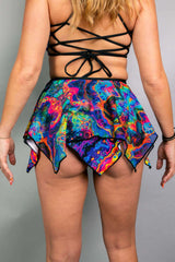 Model wearing a colorful Vivid Fairy Skirt, showcasing the double-layered handkerchief design, perfect for rave outfits.