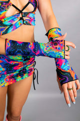 Vivid Gloves worn with a colorful rave outfit, showcasing their stylish over-the-wrist design and thumb holes.