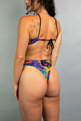 Vivid Halo Bodysuit showcasing a high-hip cut and thong back, perfect for rave outfits with colorful design.