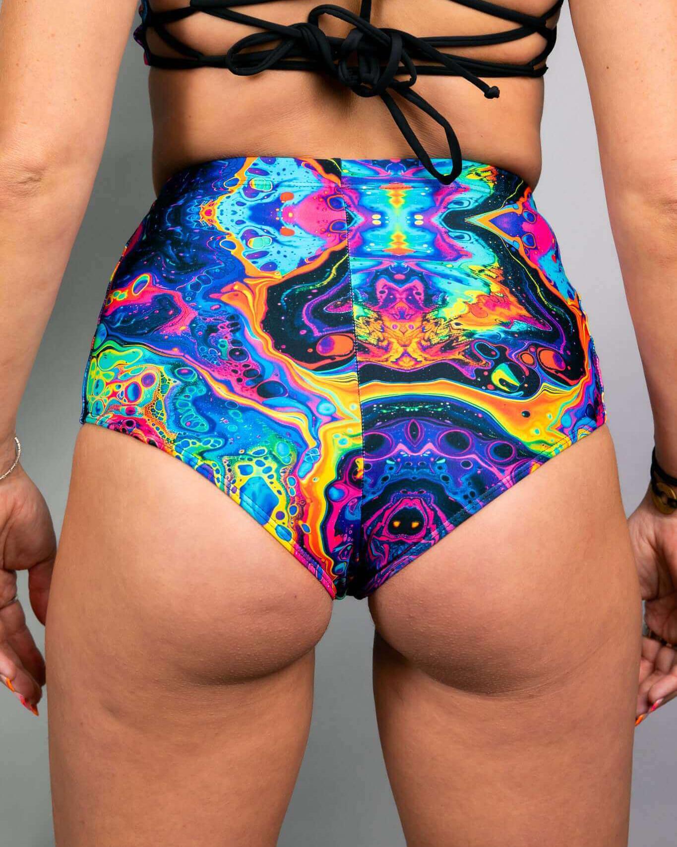 Vivid high waisted bottoms with colorful abstract design, perfect for rave outfits and added hip coverage.