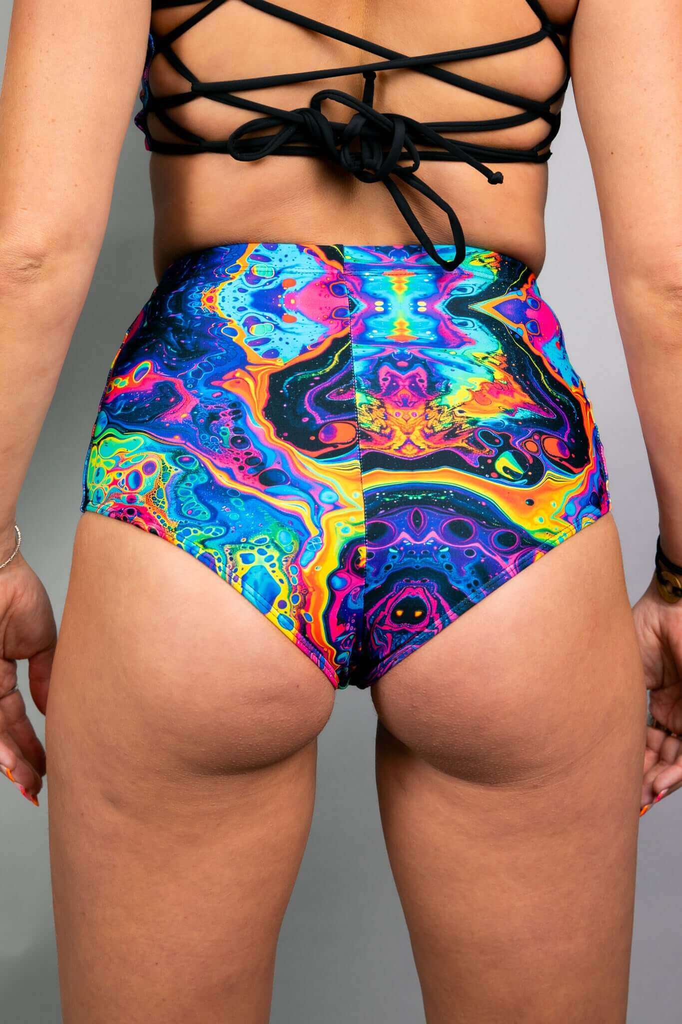 Back view of Freedom Rave Wear's swirl high-waisted shorts, highlighting the vibrant, trippy design perfect for standing out at any rave.