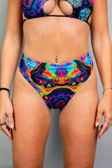 Vivid high waisted thong with trippy rainbow design, perfect for rave outfits and made from recycled materials.