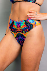 Vivid high waisted thong featuring a trippy rainbow design, perfect for rave outfits and made from recycled materials.