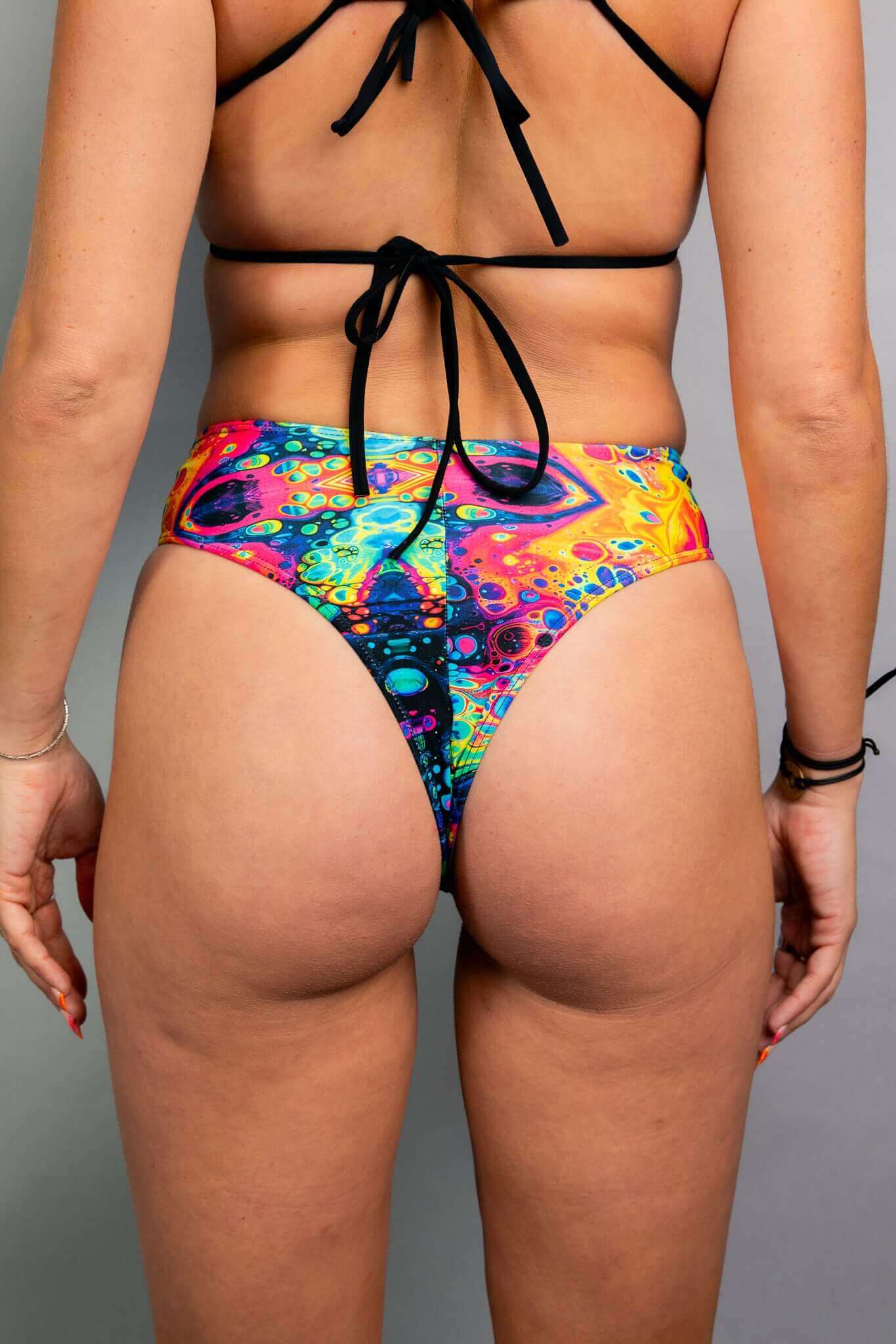 Back view of Freedom Rave Wear's high-waisted shorts featuring a vibrant psychedelic print, highlighting a flattering fit and bold design.