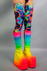 Side view of Freedom Rave Wear's psychedelic thigh-high leggings, paired with rainbow gradient platform boots, capturing the vibrant festival look.