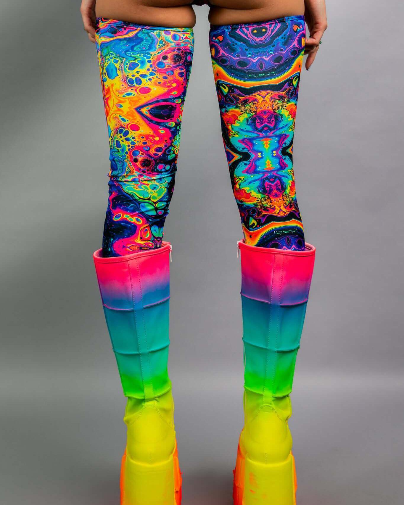 Vivid leg sleeves in vibrant colors paired with rainbow platform boots, perfect for rave outfits and festival fashion.