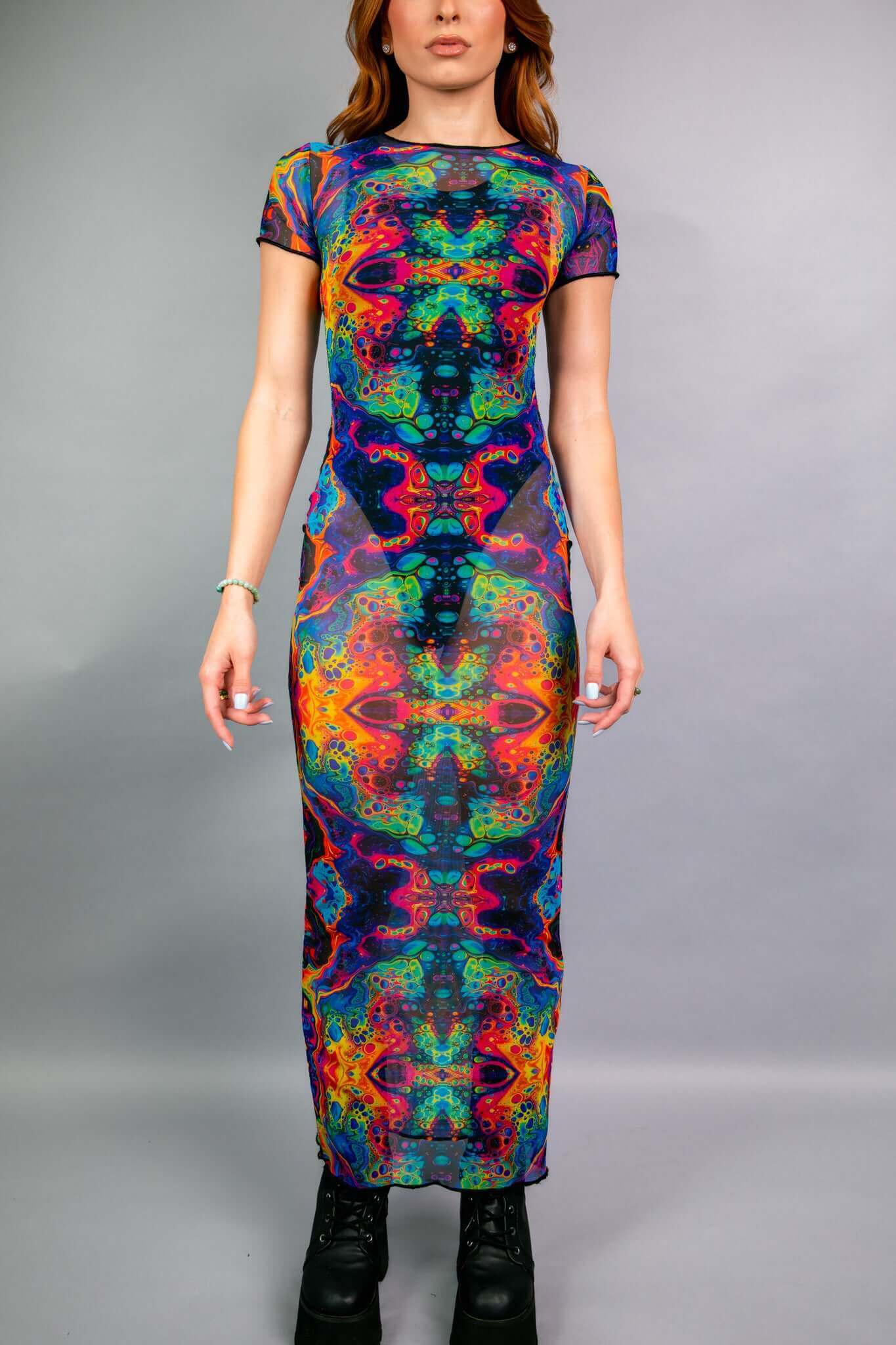 A full-length, form-fitting rave dress from Freedom Rave Wear featuring a vibrant, psychedelic pattern in neon hues