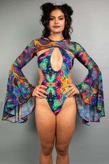 Model in Freedom Rave Wear bodysuit with dramatic cut-outs and sheer bell sleeves, highlighting a vibrant, trippy print ideal for festival fashion.