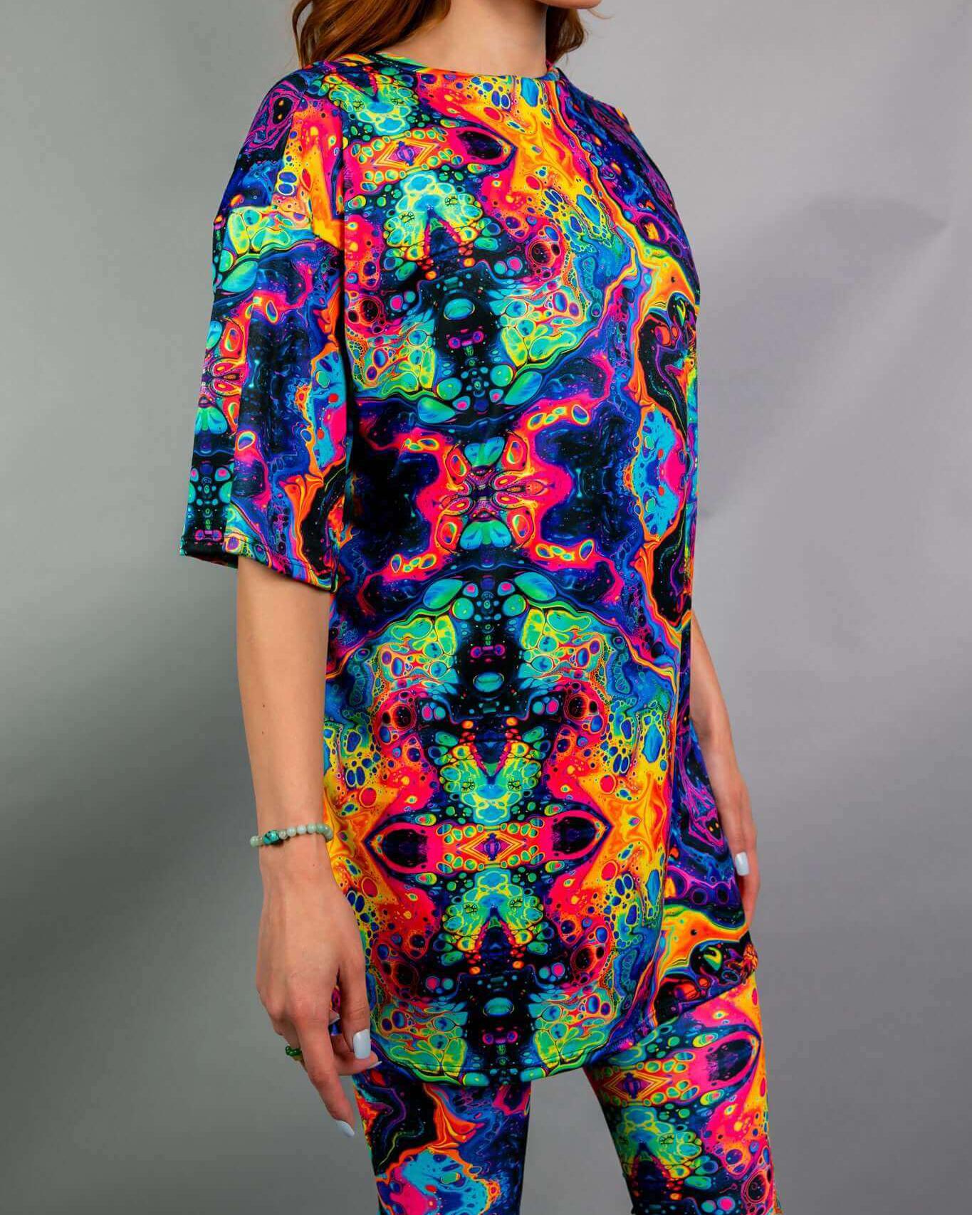 Model wearing a Vivid Oversized Softee in vibrant rainbow fabric, perfect for rave outfits and ultimate comfort.