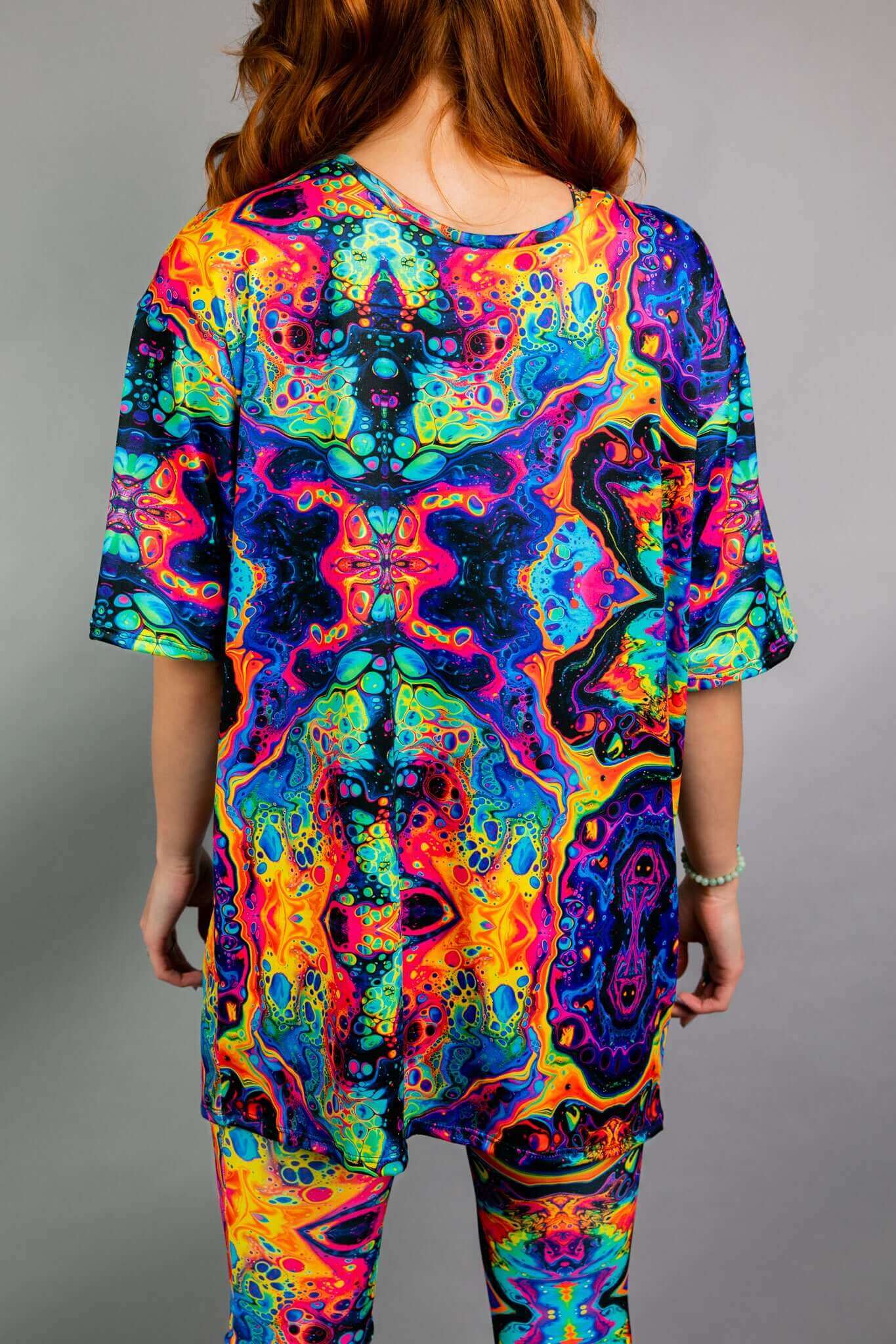 Back view of Freedom Rave Wear’s oversized shirt and leggings set, showcasing the psychedelic, vibrant print designed for a standout rave outfit.