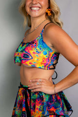 Model wearing the Vivid Shroomie reversible lush top with vibrant rainbow colors, ideal for rave outfits and festivals.