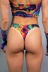 Vivid Risk Bottoms with rainbow print, perfect for rave outfits, featuring a cheeky cut and soft, stretchy fabric.