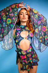 Model wearing Shroomie! Mesh Bell Sleeves with vibrant patterns, showcasing a trippy rave outfit against a blue background.