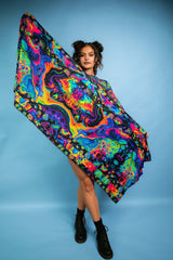 Model showcases Freedom Rave Wear’s vibrant psychedelic shawl, featuring trippy, colorful patterns. Perfect for adding a bold statement to any rave or festival outfit.