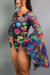 Side view of a model wearing a Freedom Rave Wear lace-up bodysuit with psychedelic mushroom and floral patterns, complete with dramatic bell sleeves.