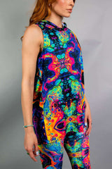 Side view of a model wearing a Freedom Rave Wear hooded top paired with matching leggings, both featuring a vibrant psychedelic pattern. Ideal for rave outfits.