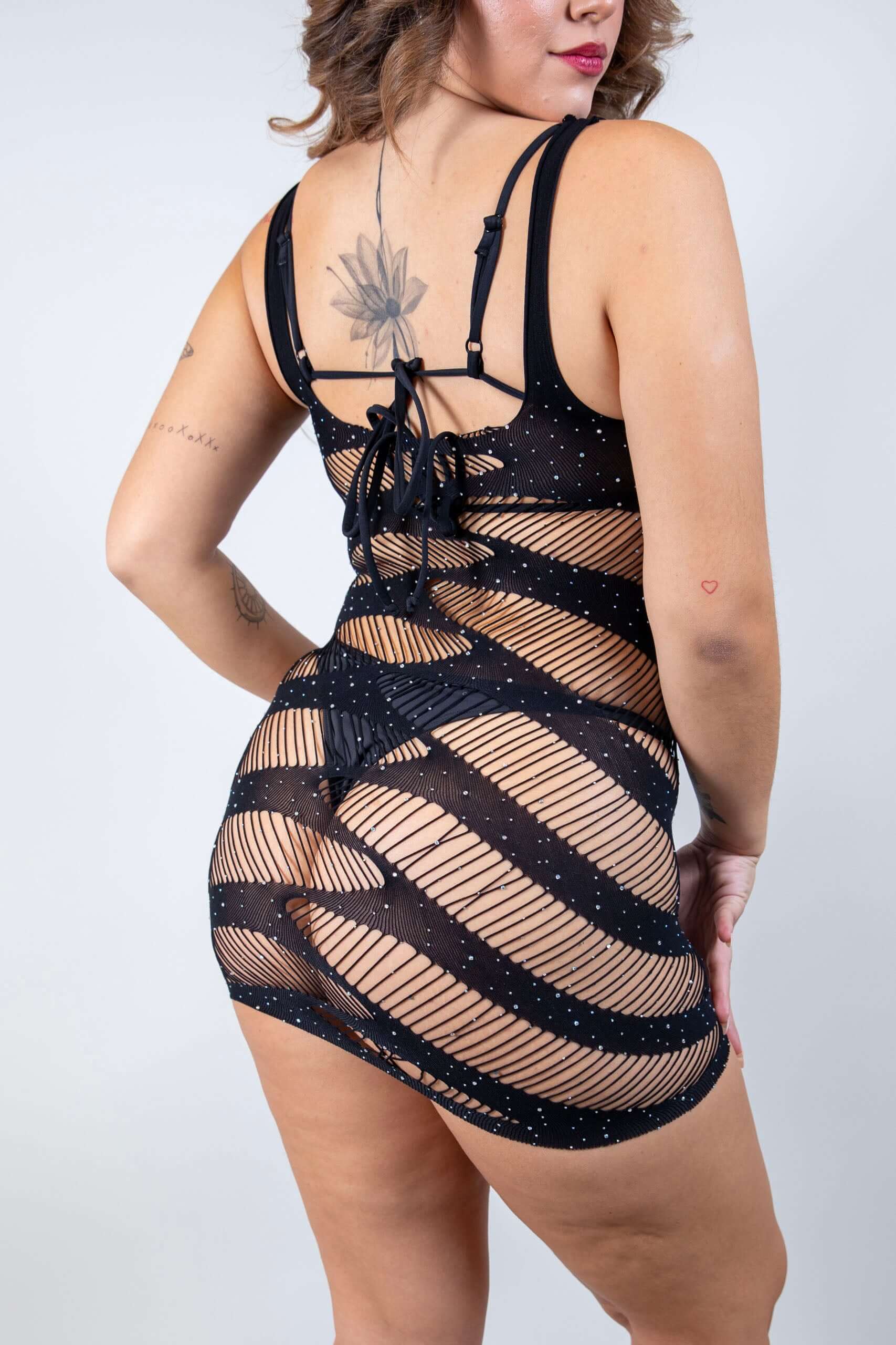 Black fishnet dress with rhinestones, showcasing a seductive back design and slits, perfect for rave outfits.