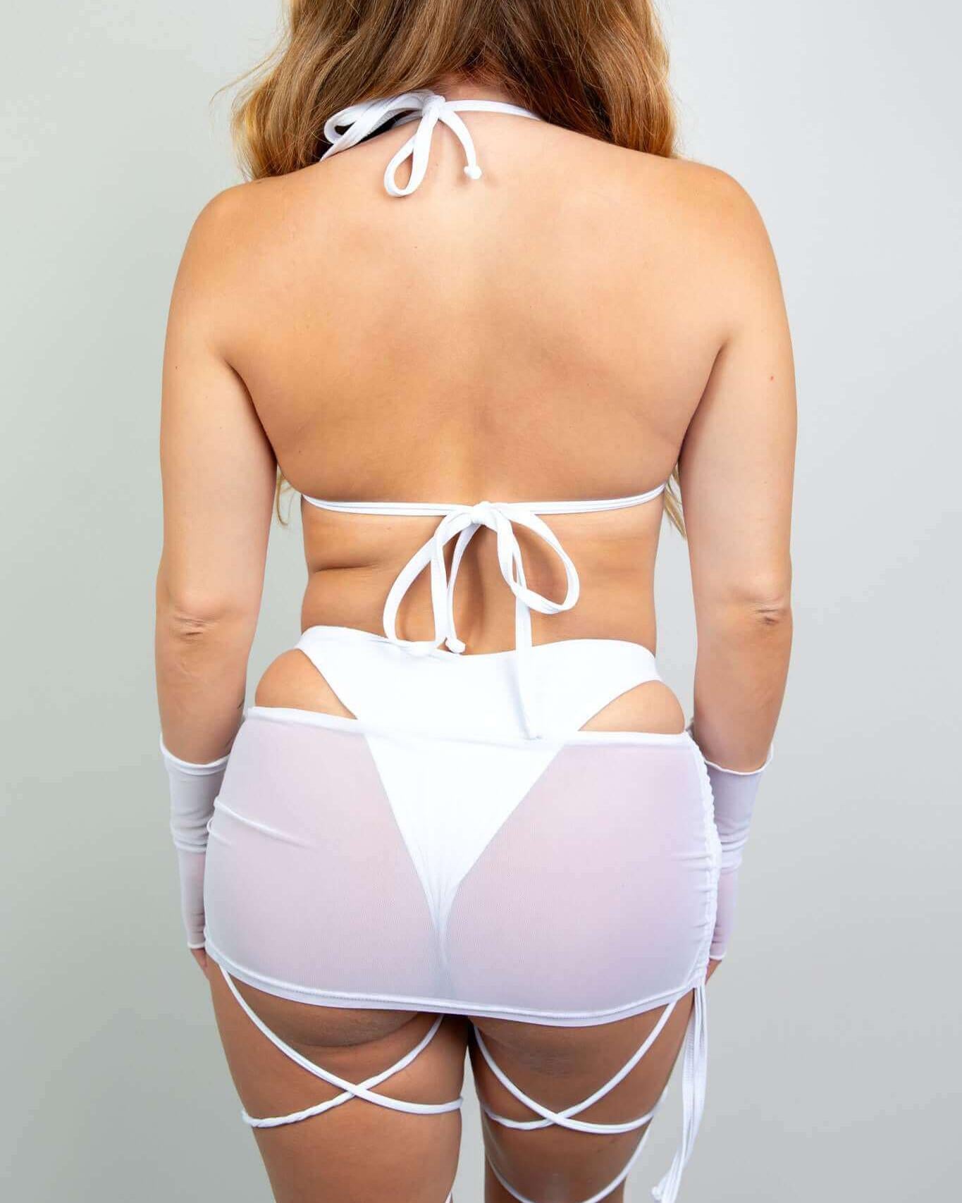 Model wearing a white mesh bikini top with adjustable straps and a matching skirt, perfect for rave outfits.