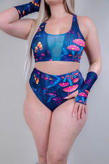 Front view of model posing in Wildwood High Waisted Bikini Bottoms, emphasizing the bold festival-inspired print.