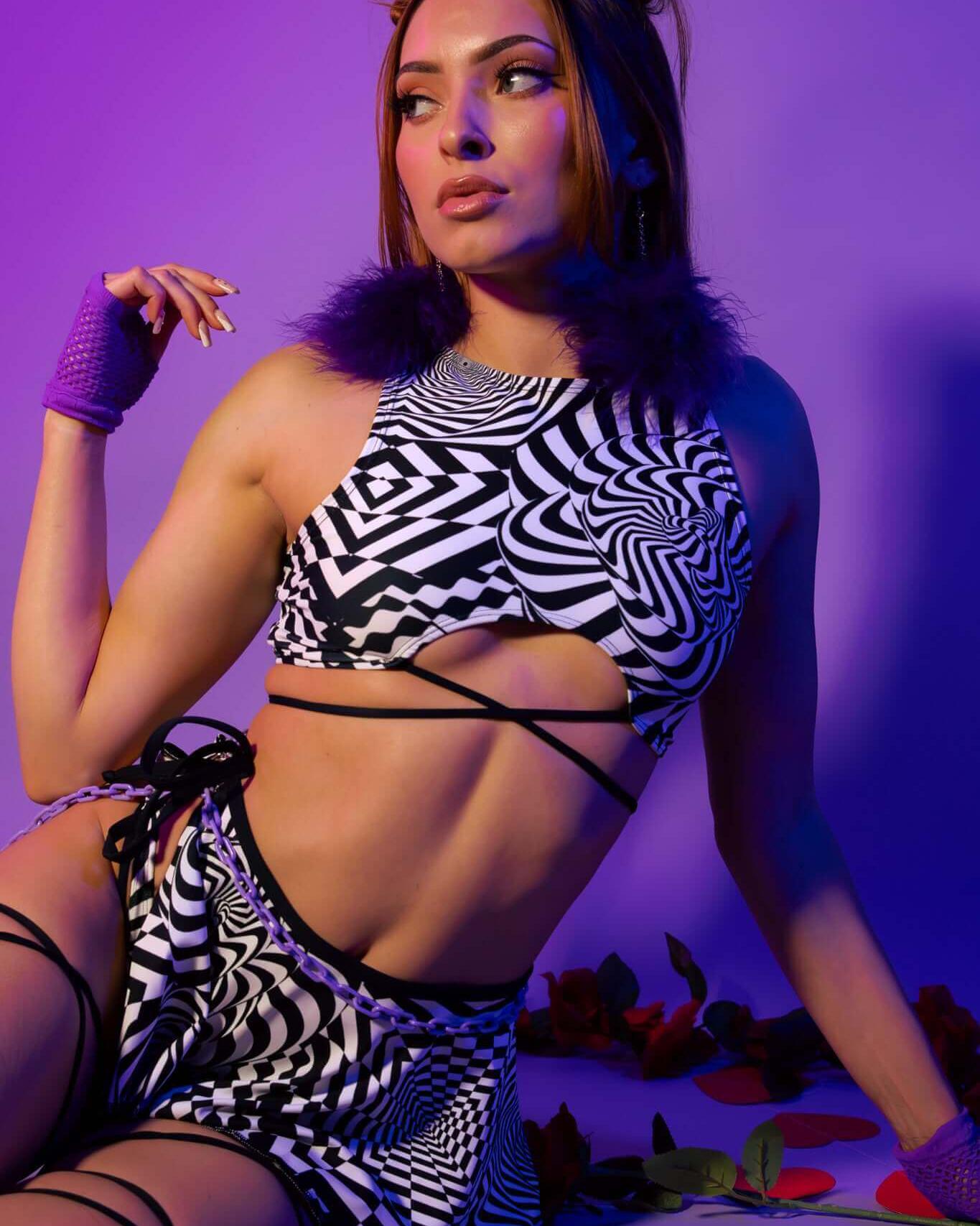 Model showcasing the Distortion Teaser Top with Straps in an abstract optical pattern for rave outfits.