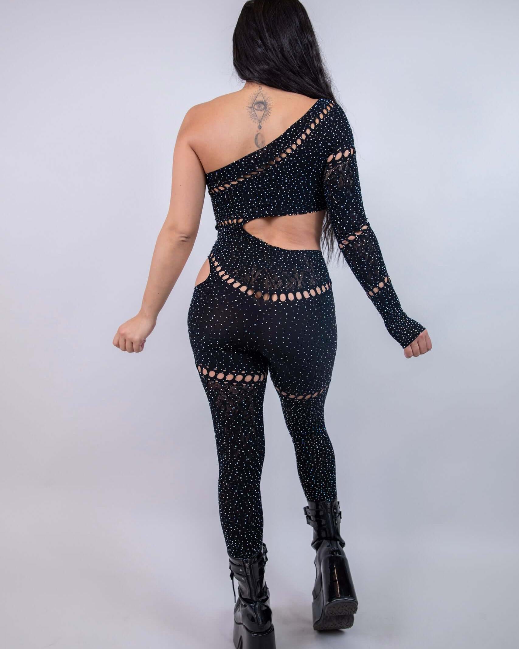 Back view of the Zoe Asymmetrical Rhinestone Jumpsuit in black, featuring cutouts and rhinestones, perfect for rave outfits.