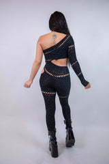 Back view of the Zoe Asymmetrical Rhinestone Jumpsuit in black, featuring cutouts and rhinestones, perfect for rave outfits.