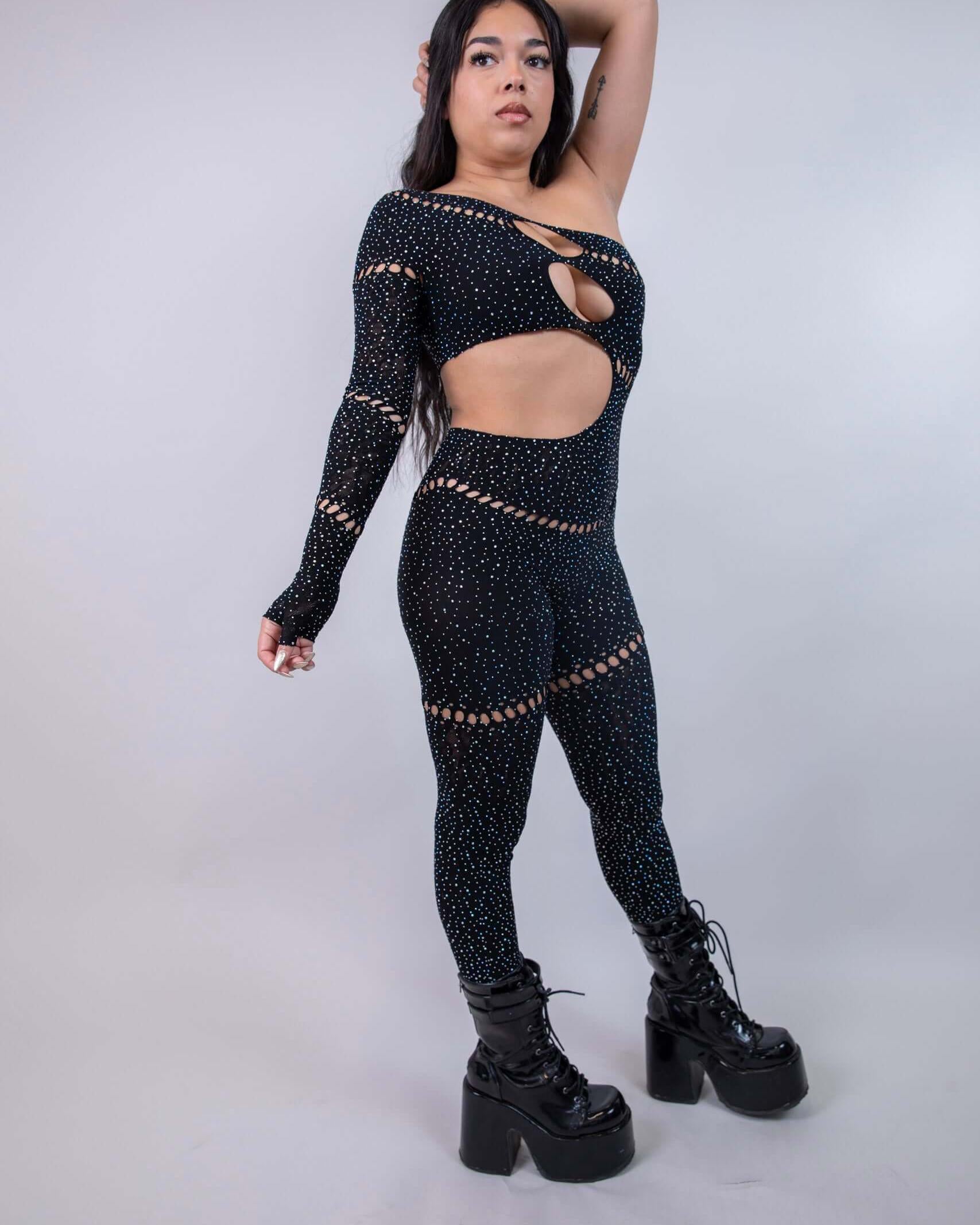 Model in The Zoe Asymmetrical Rhinestone Jumpsuit showcasing cutouts and sparkles, perfect for rave outfits.