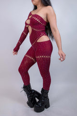 Burgundy asymmetrical rhinestone jumpsuit with cutouts, perfect for rave outfits and bold fashion statements.