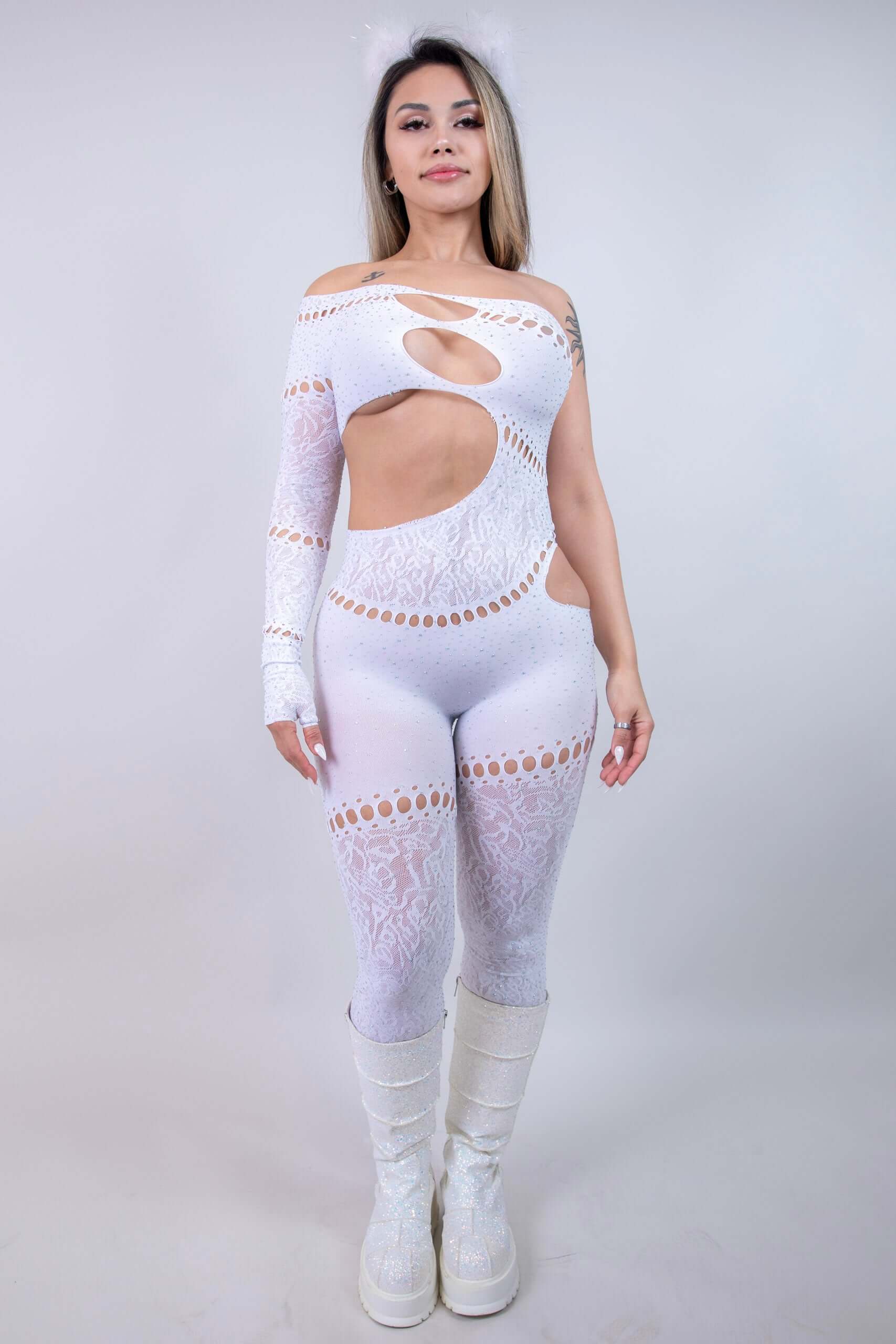 model in The Zoe Asymmetrical Rhinestone Jumpsuit, showcasing cutouts and rhinestones, perfect for rave outfits.