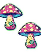 Glittery pink and yellow mushroom pasties, perfect for adding flair to rave outfits and festive occasions.