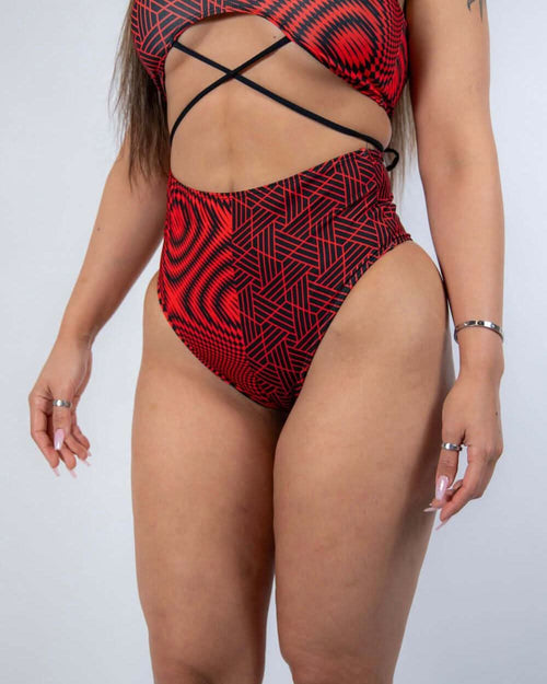 Red and black Amplitude high waisted rave pants with geometric pattern, festival outfit front view