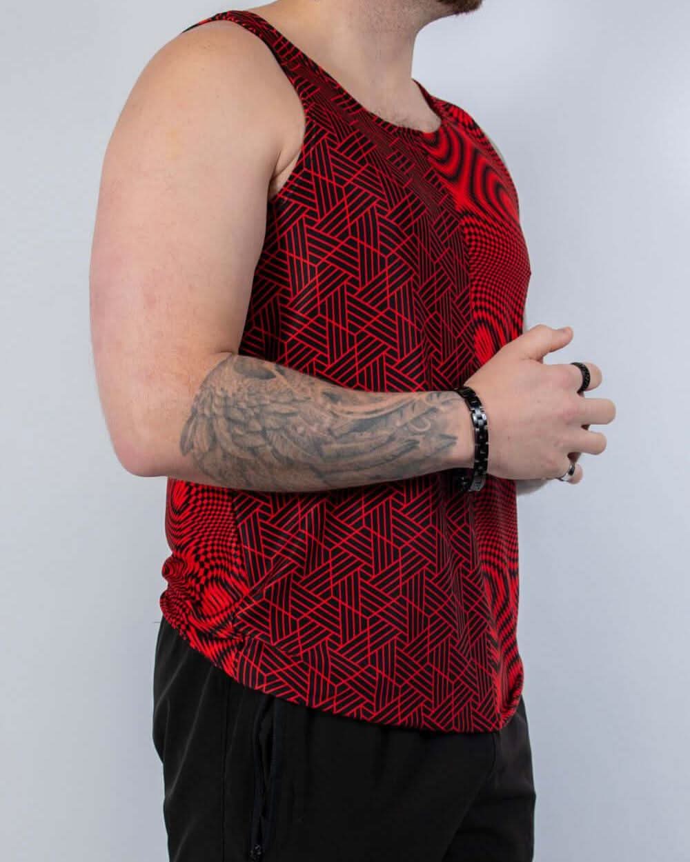 Man wearing Amplitude Men's Tank Top in bold red with abstract patterns, perfect for rave outfits.